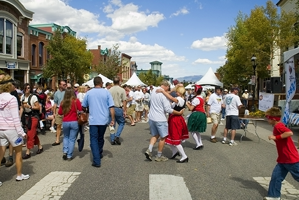 Large crowd of people celebrating and dancing the polka at an Oktoberfest celebration