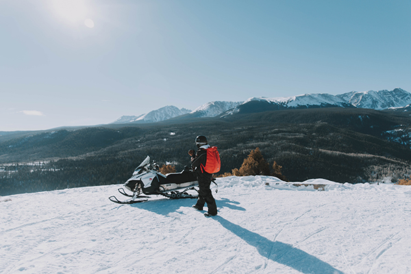 Person getting ready to ride snowmobile