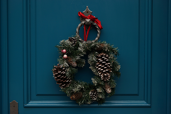 Pine cone wreath hanging on a door