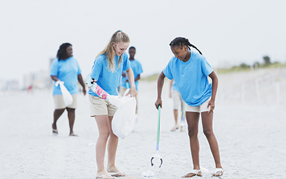 Volunteers cleaning trash off a beach