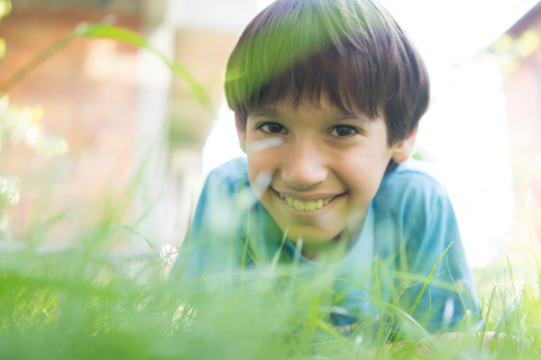 Boy laying on stomach in grass