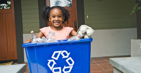 Girl holding a recycling container