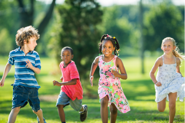 kids running in a park in summer