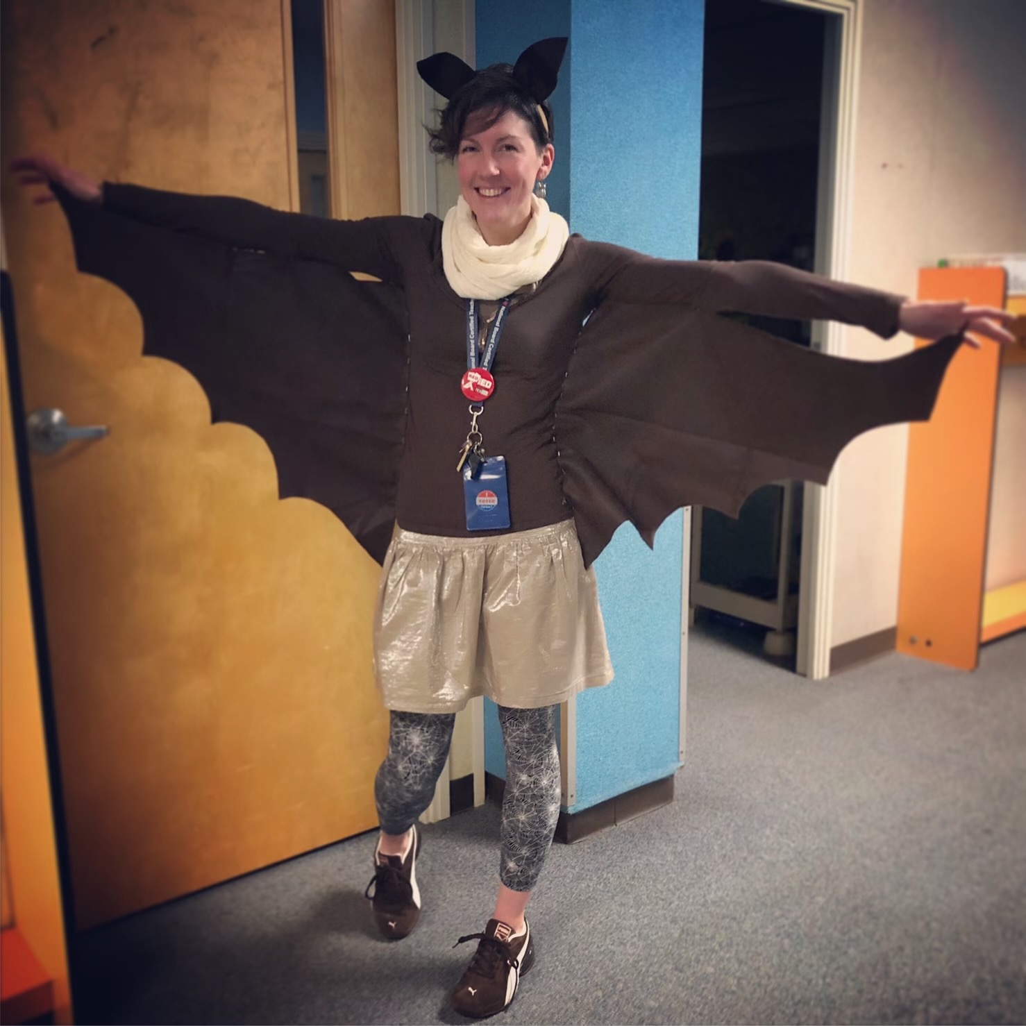 Kristin Halverson, a tall woman dressed in a costume with bat wings.