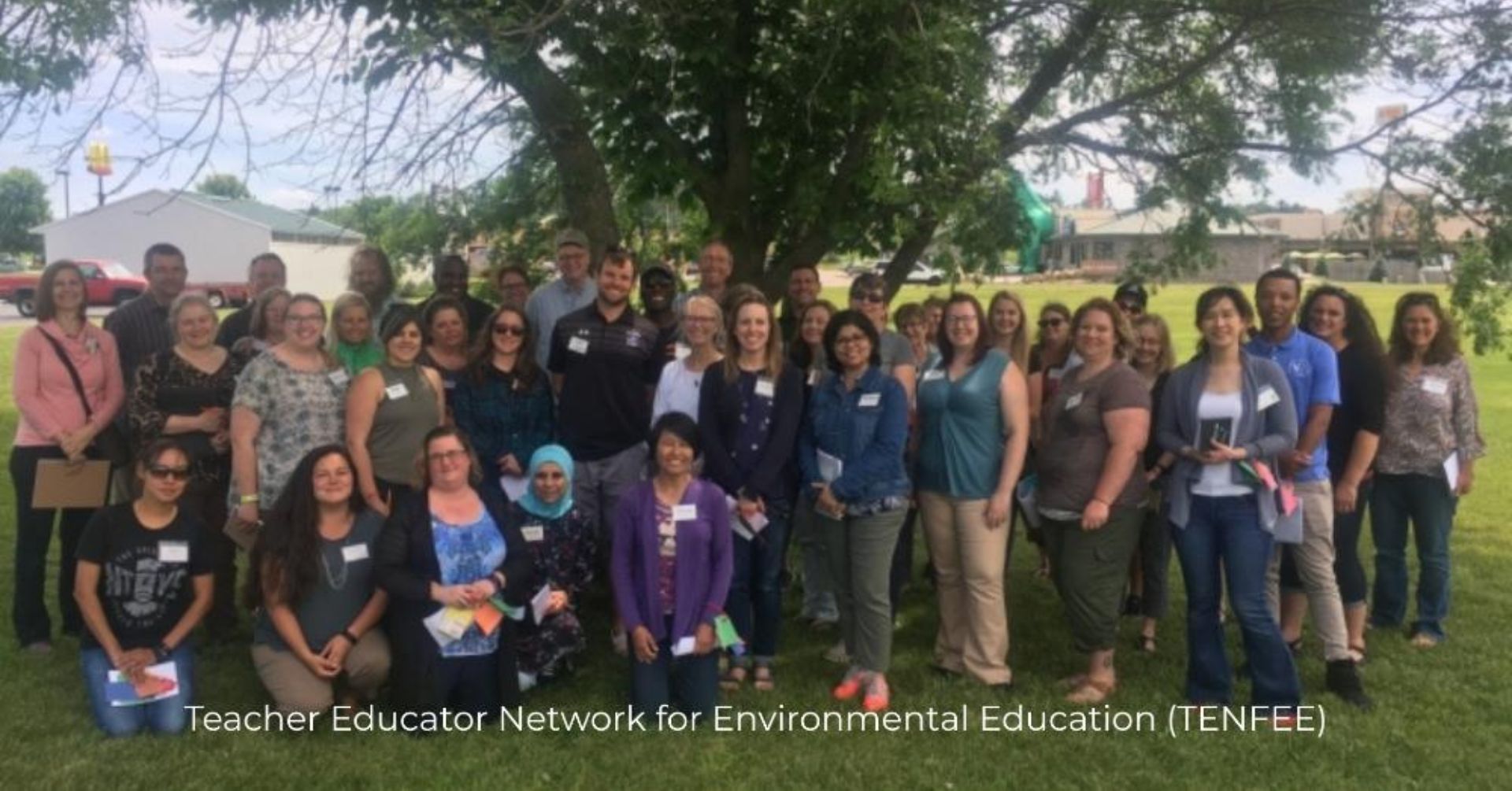 photo of educators who part of Teacher Educator Network for Environmental Education standing in front of a large tree