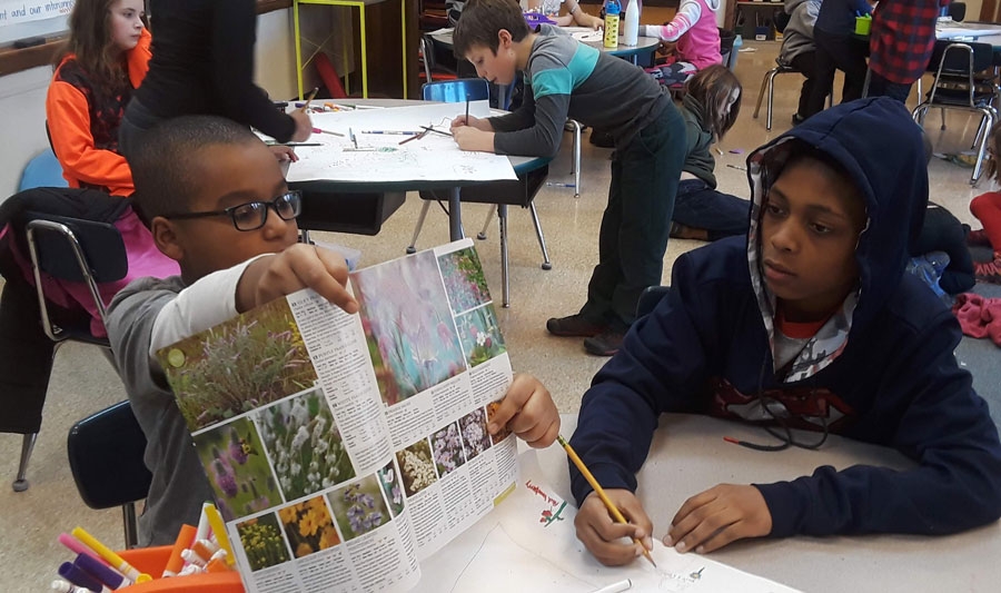 kids and teachers working in garden